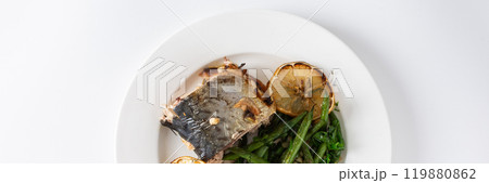 Enjoy a delicious and nutritious meal of baked green beans with onions and baked mackerel, beautifully presented on a plate against a white background, perfect for dinner, banner Enjoy a delicious and nutritious meal of baked green beans with onions and baked mackerel, beautifully presented on a plate against a white background, perfect for dinner, banner 119880862