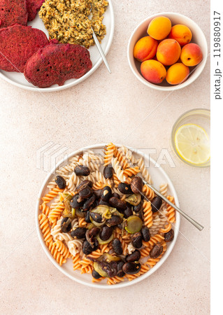 Gluten-free pasta with baked beans and zucchini, paired with beet pancakes topped with sunflower seed hummus Gluten-free pasta with baked beans and zucchini, paired with beet pancakes topped with sunflower seed hummus 119880917
