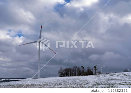 A winter landscape featuring wind turbines 119882331
