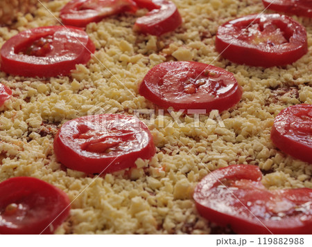 Fresh slices of tomato and cheese arranged on a rustic baking tray for pizza Fresh slices of tomato and cheese arranged on a rustic baking tray for pizza 119882988