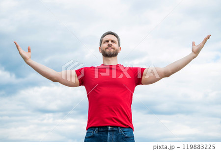proud man in red shirt outdoor on sky background proud man in red shirt outdoor on sky background 119883225