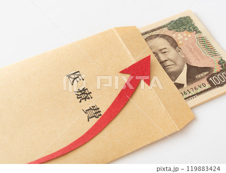 医療費の封筒に入った一万円札と上昇矢印　紙幣　封筒　支出　家計 119883424