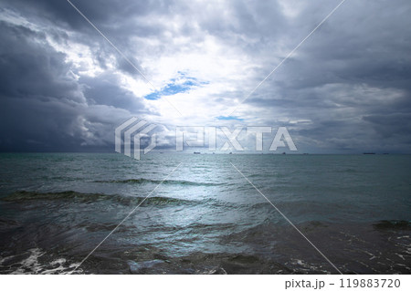 Beautiful dark evening sea and sky with dark clouds through which light passes. Beautiful dark evening sea and sky with dark clouds through which light passes. 119883720