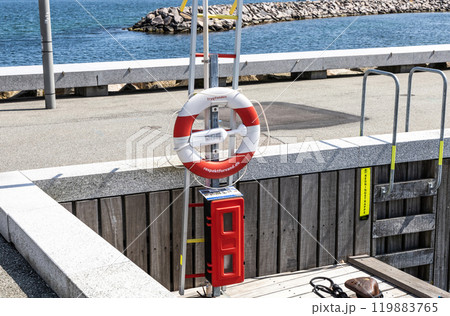 Lifebuoy hang on the pier. Concept of a safe holiday. Lifebuoy hang on the pier. Concept of a safe holiday. 119883765
