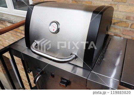 Large gas grill on the balcony. Cooking barbecue. Large gas grill on the balcony. Cooking barbecue. 119883820