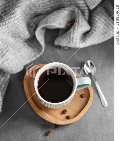 Espresso coffee in a mug on a wooden board on a dark background with coffee beans, spoon Espresso coffee in a mug on a wooden board on a dark background with coffee beans, spoon 119884019