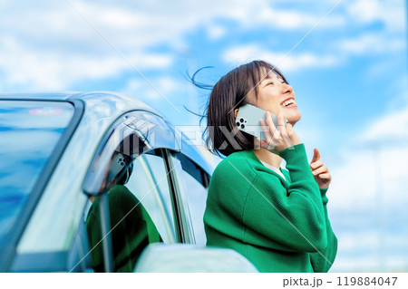 車の前で電話する女性　車のトラブルで電話する女性 119884047