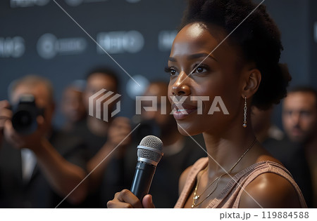 An African American PR manager confidently speaks at a press conference, holding a microphone 119884588