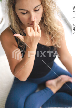 Portrait of yoga woman practice breathing pranayama asana at home closeup 119887870