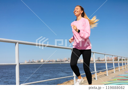 Woman jogging running on city embankment with graffiti enjoy outdoor sport activity Woman jogging running on city embankment with graffiti enjoy outdoor sport activity 119888082