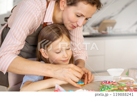 Happy family mother and children in aprons making Christmas cookies together while cooking 119888241
