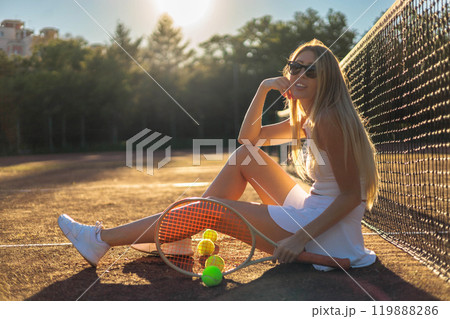 Portrait smiling woman tennis player posing with balls in hand heart shape at outdoor court closeup 119888286