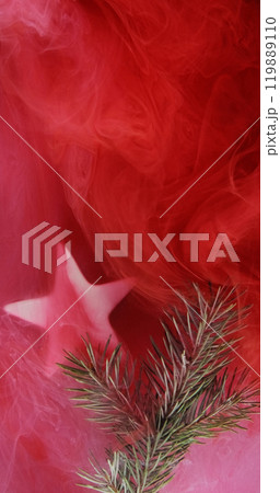 Christmas background. Mist fir sprig. Green tree plant star in red pink color paint water vapor cloud abstract texture with free space. Christmas background. Mist fir sprig. Green tree plant star in red pink color paint water vapor cloud abstract texture with free space. 119889110