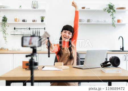 Caucasian female blogger excitedly unboxing new smartwatch for online audience 119889472