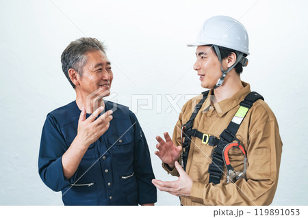 笑顔で会話する職人と作業員 119891053