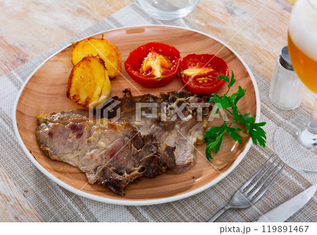 Fried pork meat with potato and tomato 119891467