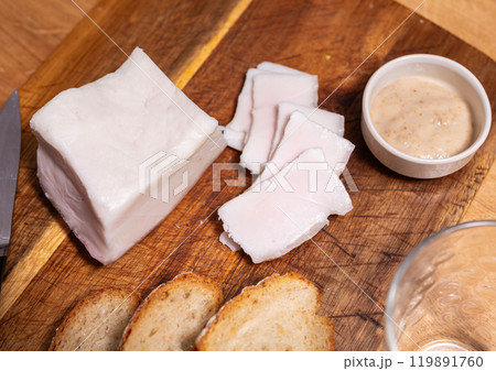 Traditional russian and ukrainian food, salted smoked pork bacon with horseradish on wooden cutting board Traditional russian and ukrainian food, salted smoked pork bacon with horseradish on wooden cutting board 119891760