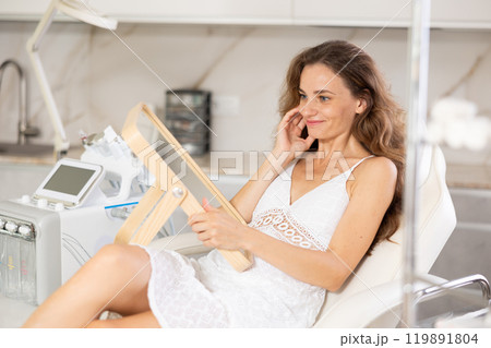 examining her reflection with satisfaction examining her reflection with satisfaction 119891804