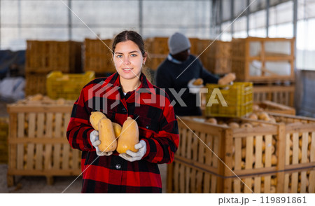 Woman farmer standing with pumpkin Woman farmer standing with pumpkin 119891861