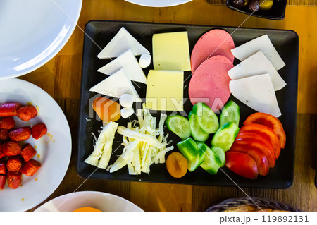 Turkish halal breakfast with cheese, sausages, eggs, vegetables, olives Turkish halal breakfast with cheese, sausages, eggs, vegetables, olives 119892131