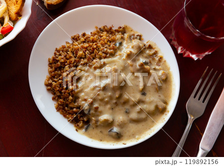 Popular dish of Russian cuisine is beef stroganoff with buckwheat porridge 119892156