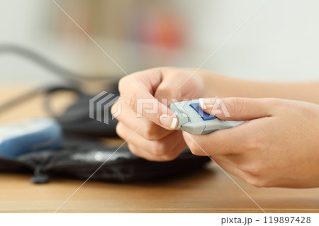 Woman hand checking blood sugar level 119897428