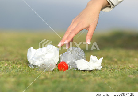 Woman hand collecting garbage in the mountain 119897429