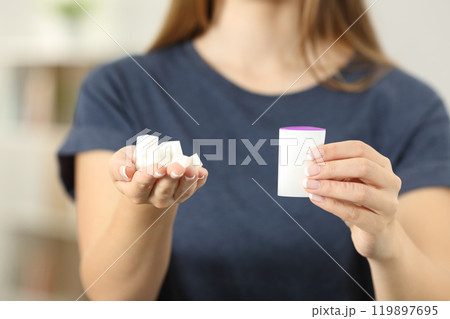 Woman hands holding sugar cubes and saccharin 119897695