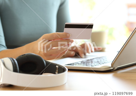 Woman hands paying music with credit card Woman hands paying music with credit card 119897699