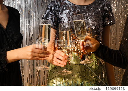 Glasses of champagne in female hands at a party 119899128
