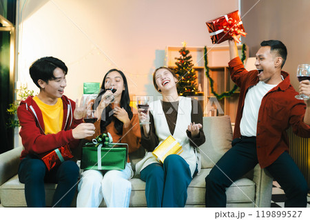 drinks and conversation, social gathering and get together at New Year young people, group and gift exchange at the event, celebration at home. 119899527