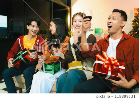 drinks and conversation, social gathering and get together at New Year young people, group and gift exchange at the event, celebration at home. 119899531