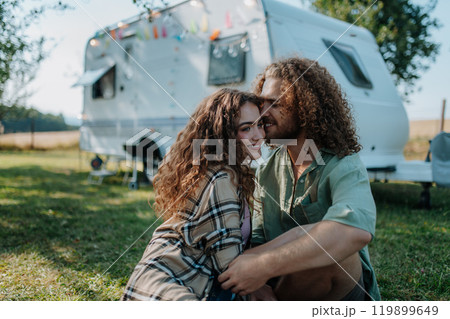 Young couple is on a camping trip in nature. Caravan traveling for young people. Young couple is on a camping trip in nature. Caravan traveling for young people. 119899649