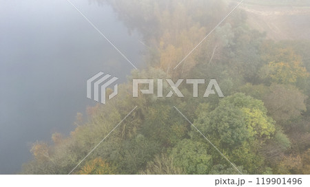 A Serene Foggy Morning Over the Lush Riverbank Landscape, Full of Enchanting Nature Beauty A Serene Foggy Morning Over the Lush Riverbank Landscape, Full of Enchanting Nature Beauty 119901496