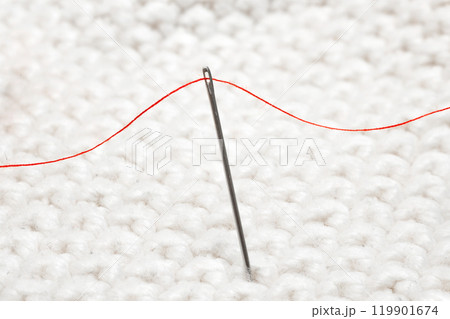 Sewing needle with red thread for sewing close-up 119901674