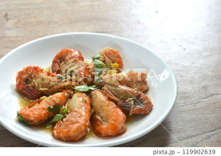 deep fried salty river shrimp with chop garlic and pepper in fish sauce arranging on plate  119902639