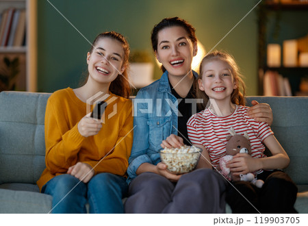 family watching TV in the evening at home family watching TV in the evening at home 119903705