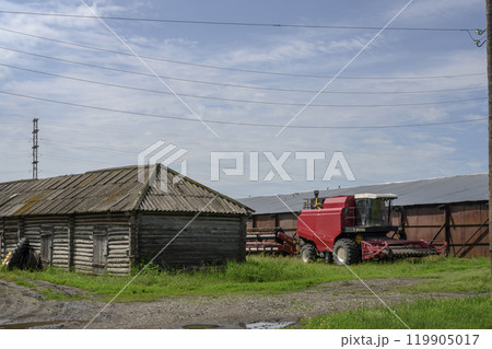 Harvester and other agricultural machinery on the outskirts of the farm 119905017
