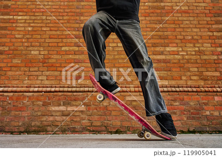 Skateboarder Performing Trick on Urban Street 119905041