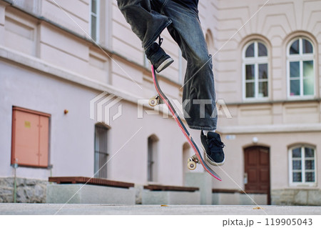 Skateboarder Performing Trick on Urban Street Skateboarder Performing Trick on Urban Street 119905043