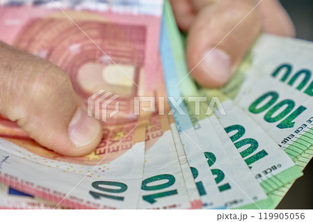 Hand Holding Euro Banknotes for Financial Transaction Hand Holding Euro Banknotes for Financial Transaction 119905056