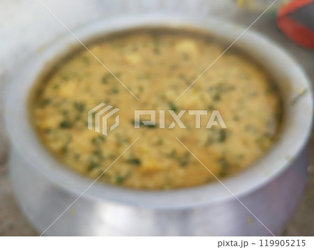 blurry image of khichdi. making khichdi in very heavy and huge pot for many peoples in village family. Dal Khichdi, a wholesome Indian comfort meal. creamy lentil and rice dish, 119905215