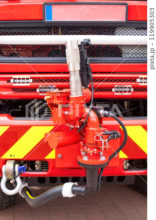 Closeup of red fire truck bumper with hoses, valves, vibrant equipment details, essential rescue operations concept Closeup of red fire truck bumper with hoses, valves, vibrant equipment details, essential rescue operations concept 119905303