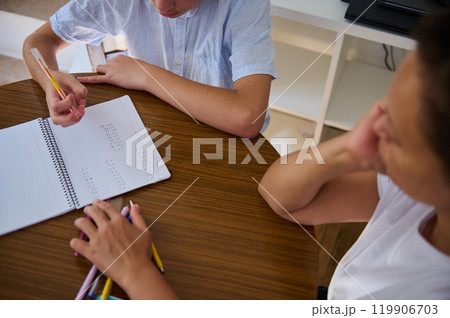 Two people working together on math homework assignment 119906703
