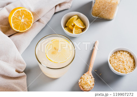 Trendy rice and lemon drink to reduce appetite in a glass on the table Trendy rice and lemon drink to reduce appetite in a glass on the table 119907272