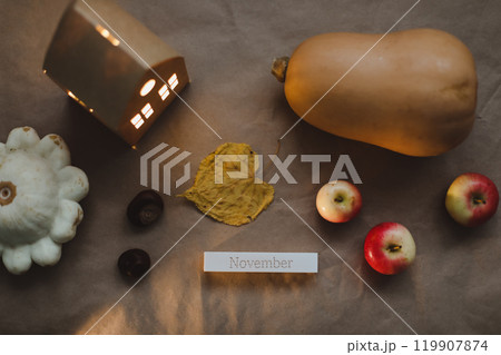 Hello autumn composition leaves, candles and pumpkin top view. Hygge cozy home decor. Halloween and Thanksgiving concept Hello autumn composition leaves, candles and pumpkin top view. Hygge cozy home decor. Halloween and Thanksgiving concept 119907874
