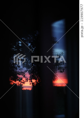 Sunset clouds mirrored in the window. Nature sunset sky backdrop. Blurry abstract sunrise background 119907977