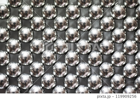 magnetic ball bearing tiling in perfect hexagonal grid. Metal balls close up. Balls of neodymium (magnets). magnetic ball bearing tiling in perfect hexagonal grid. Metal balls close up. Balls of neodymium (magnets). 119909256