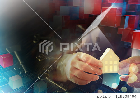 Real estate concept. Paper house and keys on a wooden background. Real estate concept. Paper house and keys on a wooden background. 119909404