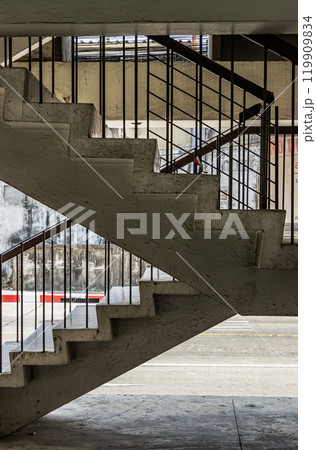 Side view of Old concrete staircases with railings pattern in the old apartment building architecture. 119909834